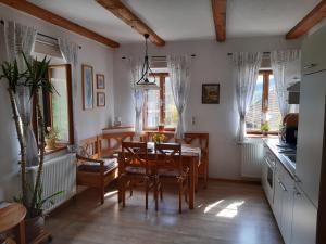 a kitchen and dining room with a table and chairs at Nussbaumerhof in Sankt Michael am Bruckbach
