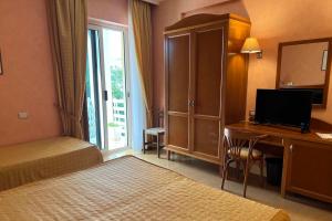 Postel nebo postele na pokoji v ubytování Hotel Conchiglia d'Oro