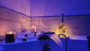 a bathroom with a sink with candles and a bottle at Majestic Salus Spa in Fiuggi