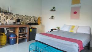 a small bedroom with a bed and a kitchen at 5 Beach Suite wpool sea access in La Libertad +24 photos