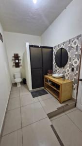 a bathroom with a sink and a mirror and a toilet at 5 Beach Suite wpool sea access in La Libertad