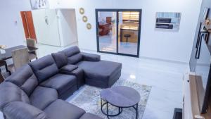 a living room with a couch and a table at Siesta Apartments in Lusaka