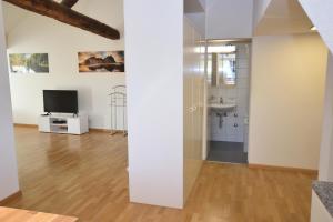 a room with a sink and a tv and a mirror at Loft in the historical center - Symbol 4 in Zürich +10 photos