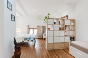 a bedroom with a bed and a book shelf at Casa Velella in Castellammare del Golfo