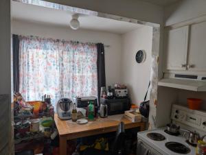 a kitchen with a table and a window and a counter at Chez Walid in Montreal