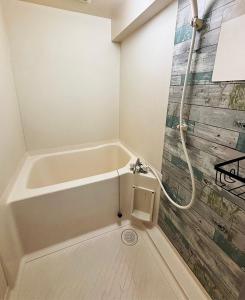 a bathroom with a bath tub and a shower at SKY HOTEL - Yokohama - in Yokohama +17 photos