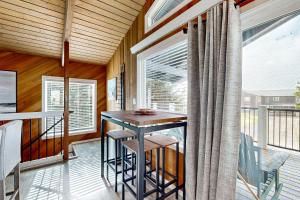 a porch with a table and chairs on a balcony at The Sand Ranch in Rockaway Beach