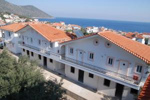 a row of white buildings with orange roofs at Areti Studios in Tyros