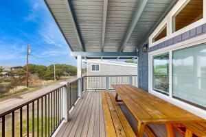 a deck with a wooden bench on a house at The Sand Ranch in Rockaway Beach