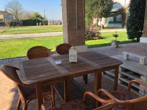 a wooden table and chairs on a patio at Agriturismo Villa Greggio in Casalserugo
