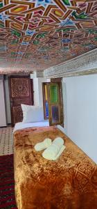 Postel nebo postele na pokoji v ubytování Dar Amazigh