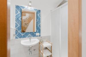 a bathroom with a sink and a mirror at Casa Velella in Castellammare del Golfo +35 photos