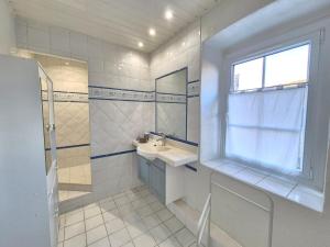 a white bathroom with a sink and a window at Montpeyruvienne #Jardin#Parking in Montpeyroux +23 photos