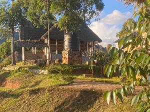 an old house with a silo in front of it at Usambara Sunsetview Lodge in Lushoto