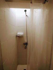 a bathroom with a shower with a shower curtain at Tigre Center in Tigre +13 photos