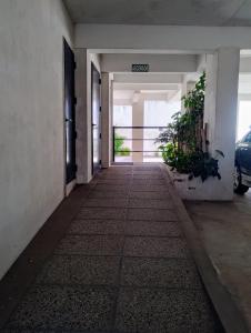 an empty hallway of an office building with a door at Tigre Center in Tigre