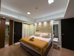 a bedroom with a large bed in a room at Modern 1BR Unit in Abreeza Place T2 with Pay Parking in Davao City +6 photos