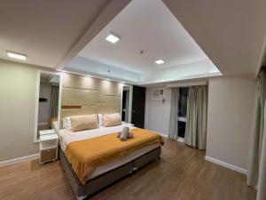 a bedroom with a large bed in a room at Modern 1BR Unit in Abreeza Place T2 with Pay Parking in Davao City