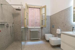 a bathroom with a toilet and a sink and a shower at Studio Caspani - Duomo Centro Storico in Como +20 photos