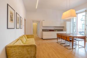 a living room with a couch and a table at Studio Caspani - Duomo Centro Storico in Como