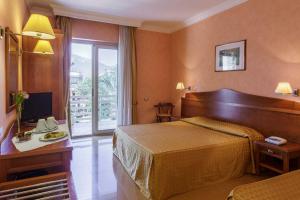 Postel nebo postele na pokoji v ubytování Hotel Conchiglia d'Oro