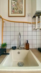 a white sink in a kitchen with at Chic 1-Bedroom appartment on Saburtalo in Tbilisi City