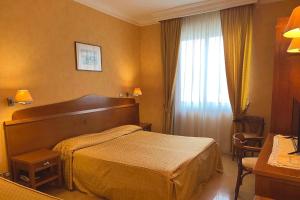 Postel nebo postele na pokoji v ubytování Hotel Conchiglia d'Oro