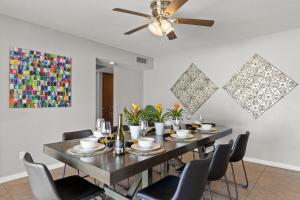 a dining room with a table with chairs and a ceiling fan at Minnezona in Scottsdale +28 photos