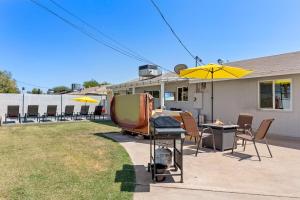 a backyard with a grill and a table and umbrella at Minnezona in Scottsdale
