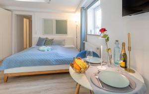 a bedroom with a bed and a table with fruit on it at Ruhig Top mod Studio Appartement,privater Eingang in Oberhaching