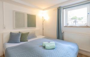 a bedroom with a bed with a pillow on it at Ruhig Top mod Studio Appartement,privater Eingang in Oberhaching