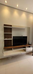 a living room with a flat screen tv on a wall at White River in Boa Vista