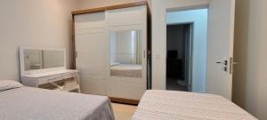 a bedroom with a mirror and a bed and a bed sidx sidx sidx at White River in Boa Vista