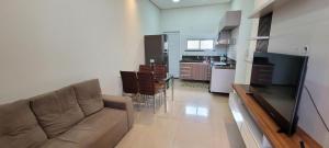 a living room with a couch and a kitchen at White River in Boa Vista