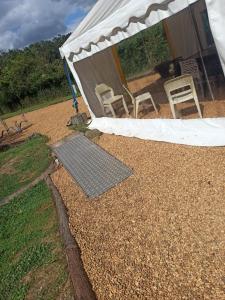 a tent with chairs and a solar panel on the ground at Gite La Trotiniere in Luynes