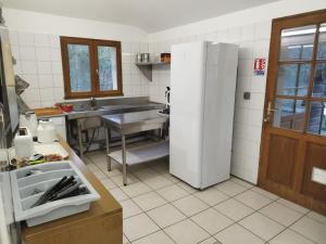 a kitchen with a sink and a refrigerator at Gite La Trotiniere in Luynes +17 photos