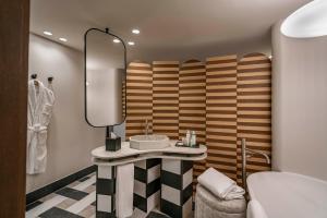 a bathroom with a sink and a mirror at Vincci Soho in Madrid