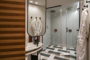 a bathroom with a mirror and a shower at Vincci Soho in Madrid