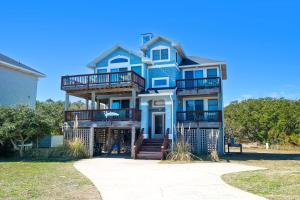 a blue house with balconies on the side of it at Oceanside, Close to Beach, Hot Tub- OS5H, Long Beach Day in Corolla
