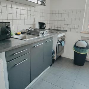 a kitchen with a sink and a stove at Monteur-Ferien-Messewohnung Mettmann 6 Personen 2 OG in Mettmann +16 photos