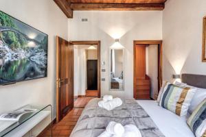 a bedroom with a bed with towels on it at Casa Navona Apartments in Rome +94 photos