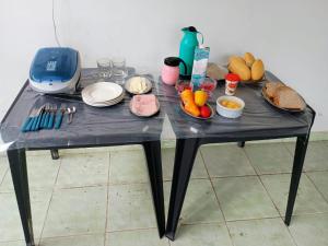 a black table with some food on it at Suíte no Barra Mar in Barra de São Miguel
