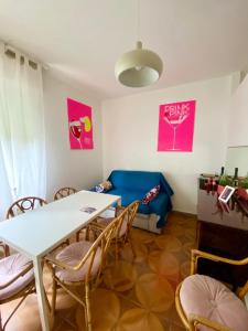a living room with a table and chairs and a couch at Palma 12 in Lignano Sabbiadoro