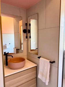 a bathroom with a large sink and a large mirror at Palma 12 in Lignano Sabbiadoro +10 photos