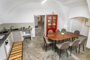 a kitchen and dining room with a wooden table and chairs at BeRGAMO ALTA - Piazza Mercato del Fieno HOUSE in Bergamo
