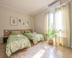 En eller flere senge i et værelse på Italian Experience- Lory House