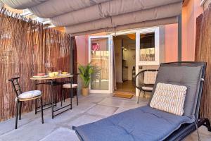 a porch with a chair and a table on a patio at Cosy Bungalow Green Oasis in Maspalomas