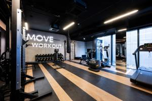 a gym with treadmills and a movie workshop sign on the wall at Native Apartments Kościuszki 39/5 in Kraków
