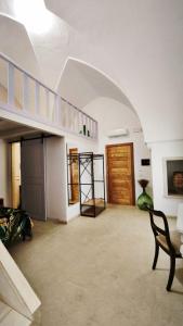 a living room with a staircase and a table and a chair at La Corte nel Vico in Leverano