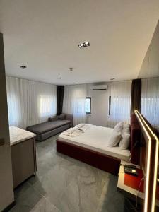 a bedroom with a large bed and a couch at Abone Suites in Istanbul +9 photos